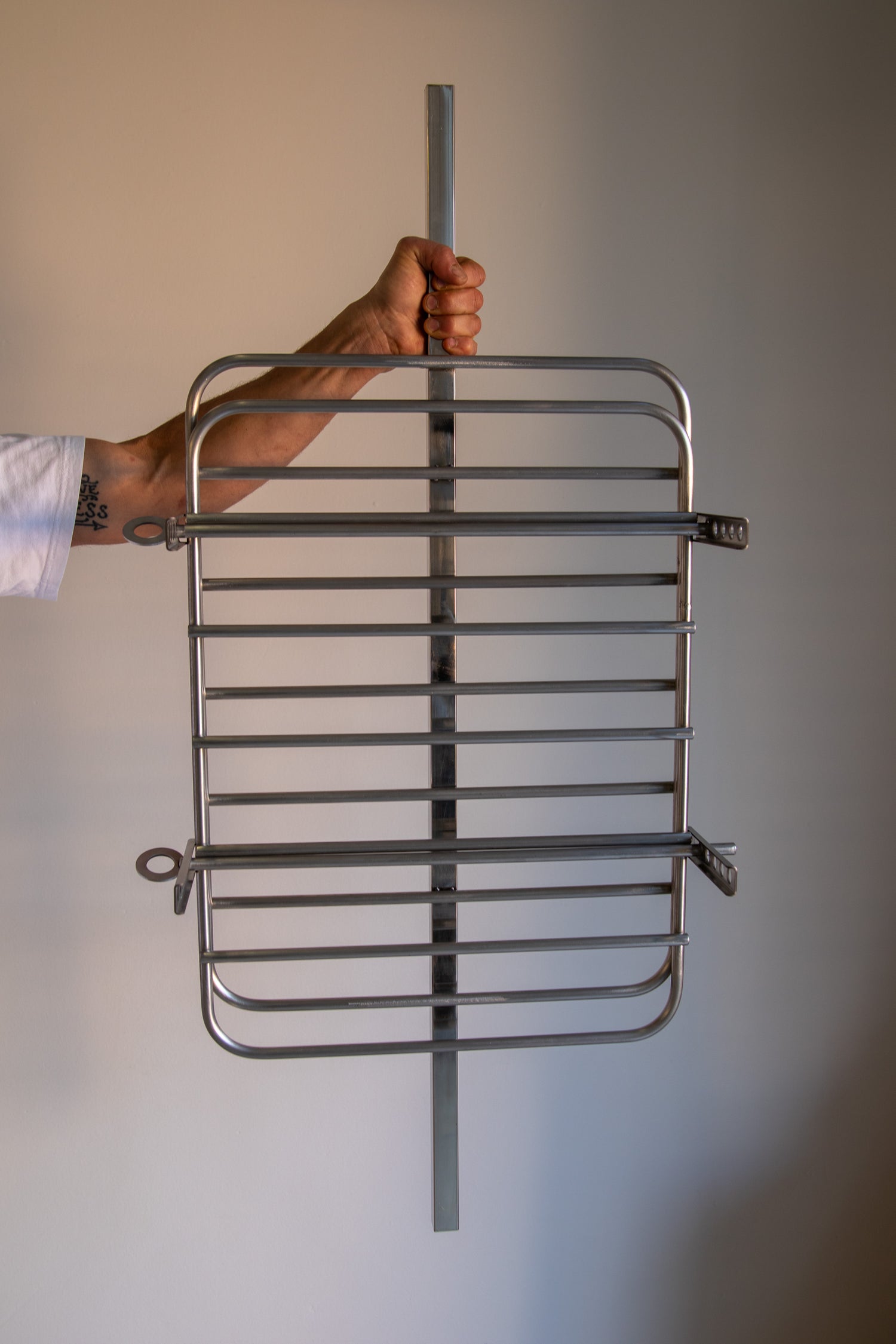 Traditional Argentinean metal cooking press for slow-roasting large cuts