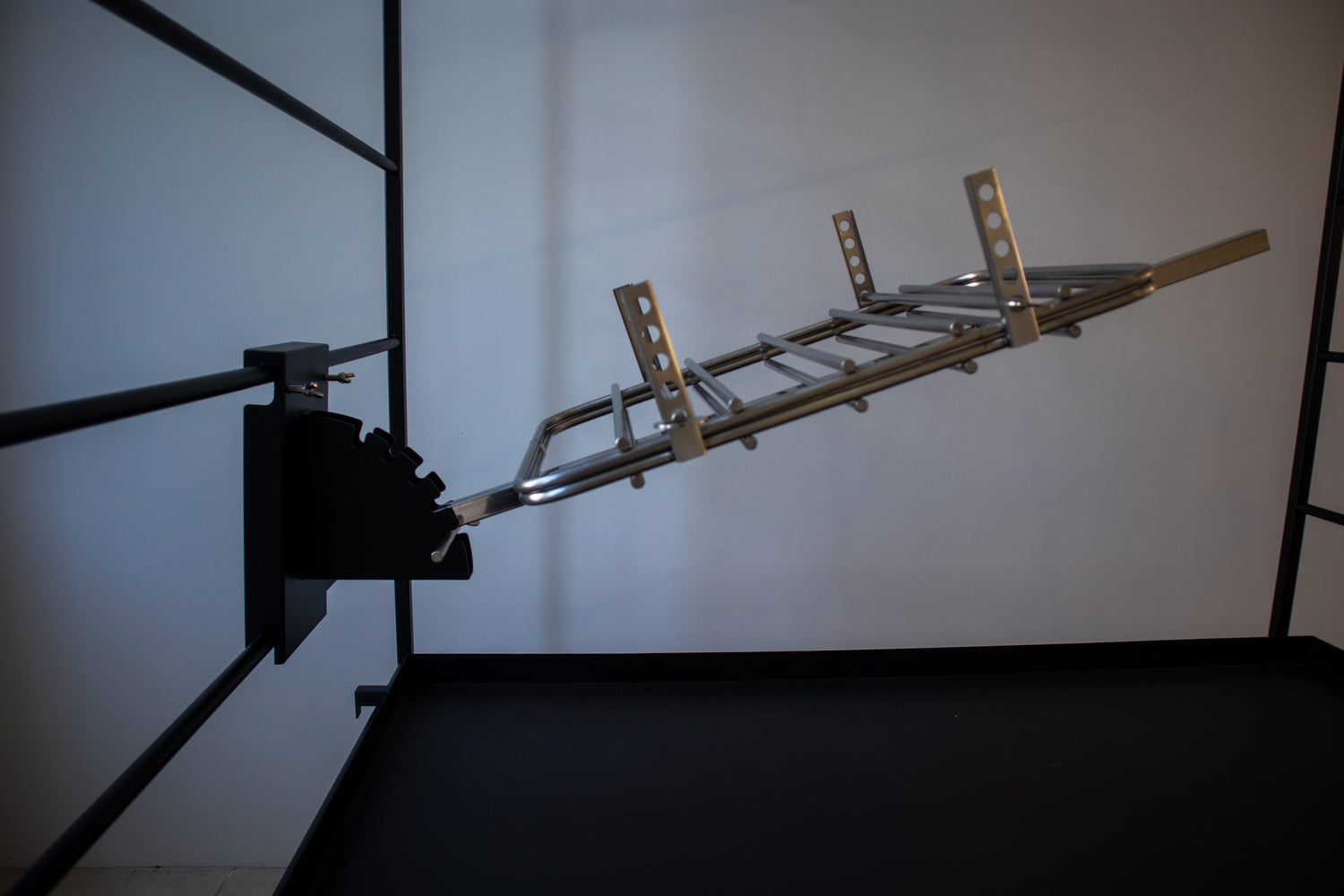 Close-up of The Press metal frame construction and adjustment mechanism