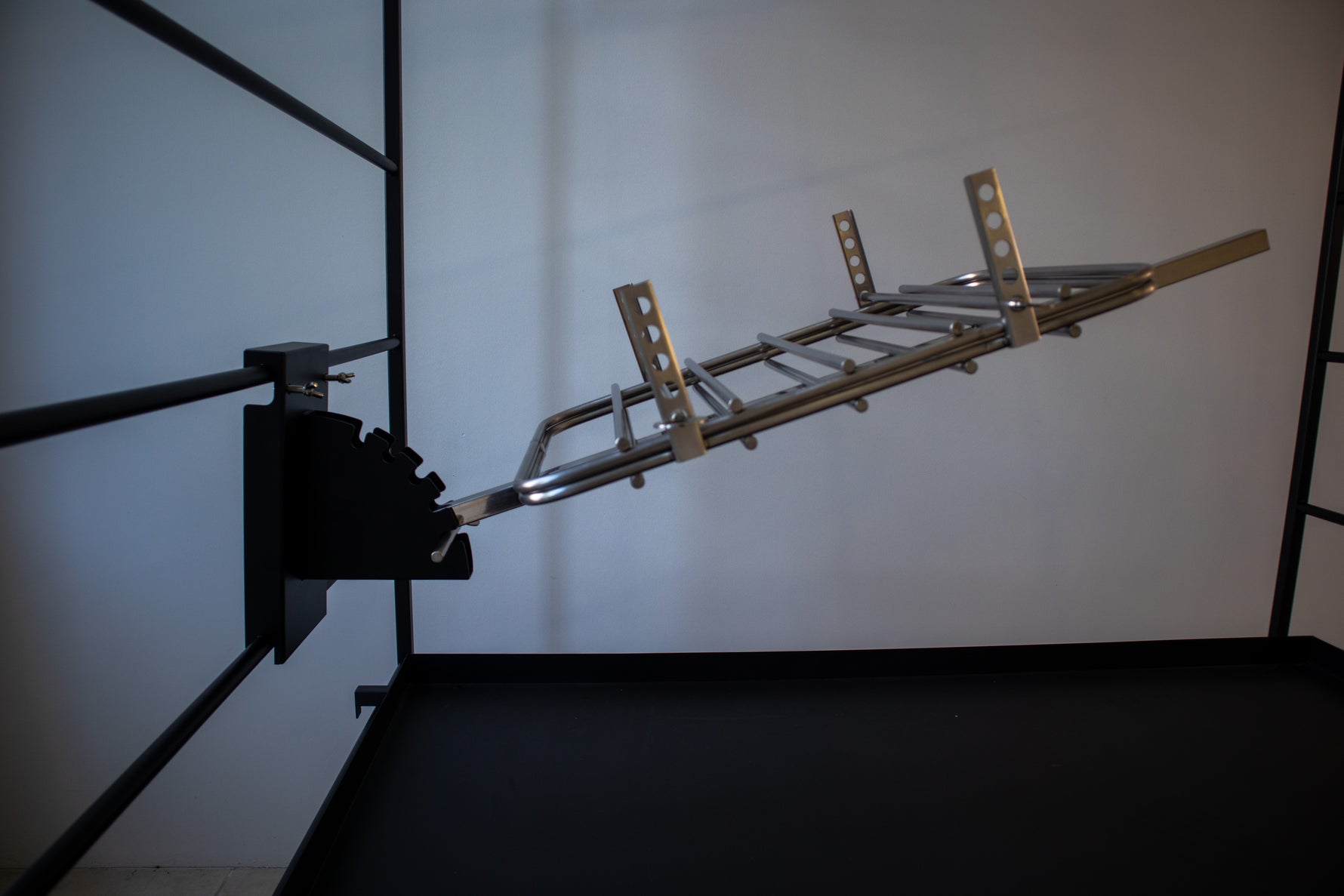 Close-up of The Press metal frame construction and adjustment mechanism