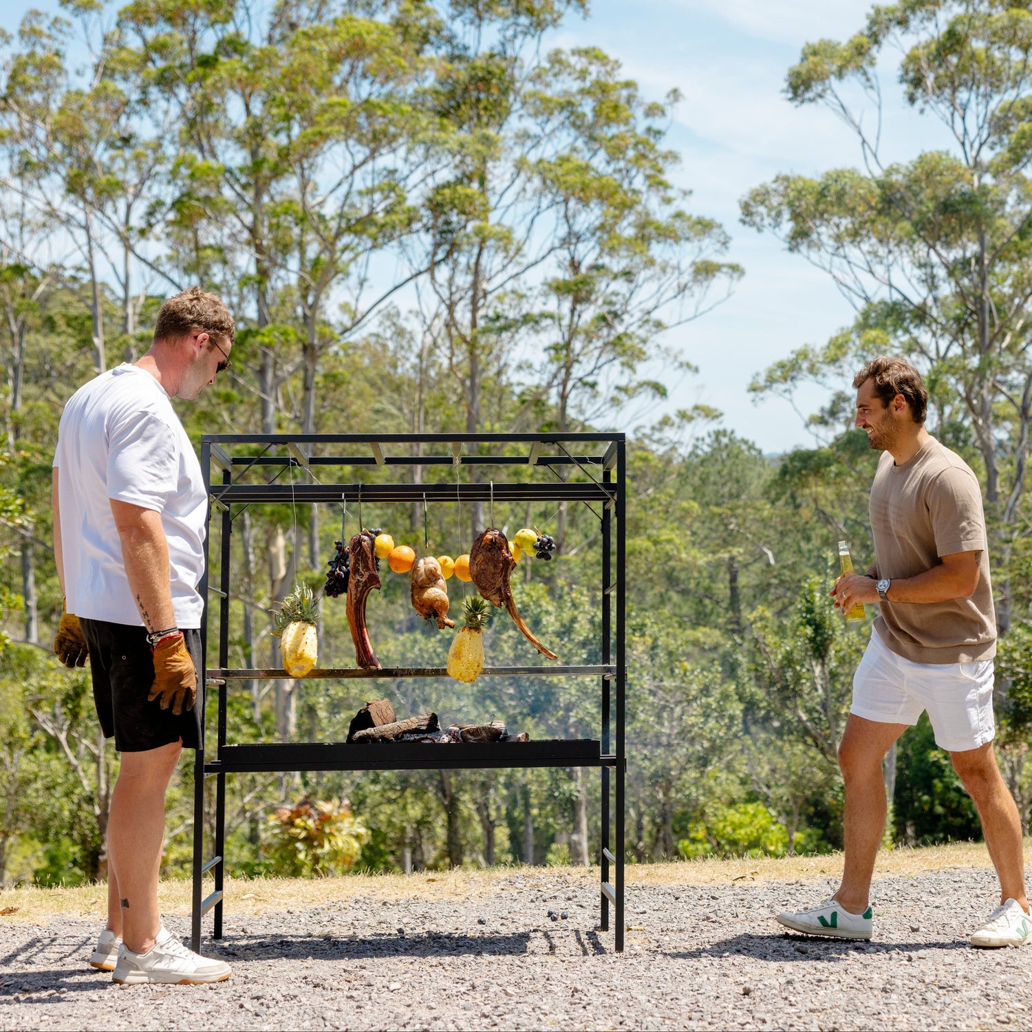  Lifestyle shot of people gathered around a Terra Grill at an outdoor event