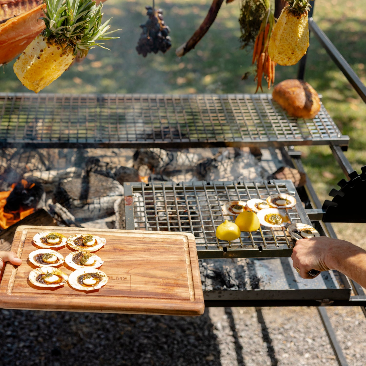 Outdoor cooking scene with a grill and cutting board. Portico Large grill with Churrasco skewers for authentic South American cooking
